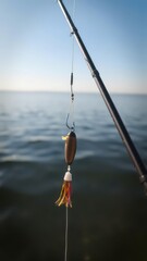 Close-up of fishing rod with hook and bait attached, on a calm and serene lake, hook