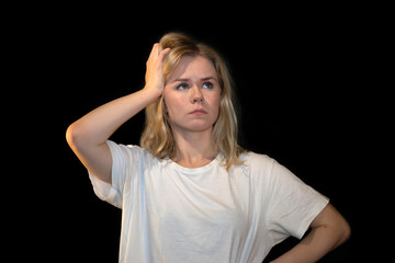 Concerned Woman with Hand on Head Looking Thoughtful on Black Background