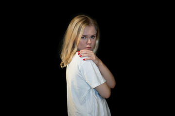 Schoked and scared Young Woman in white t-shirt Expressing Shock and covering with her hands
