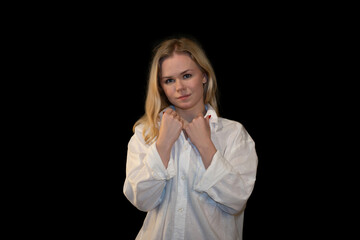Portrait of a young woman in a white shirt against a dark background