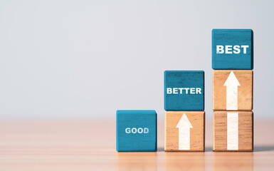 Good better and best wording on blue wooden cube block with white up arrow for product and service...