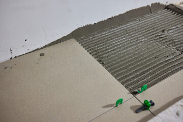 The Comprehensive Tile Installation Process Using Adhesive Techniques and Methods