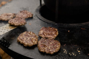 Sizzling, Mouthwatering Burgers Cooking Perfectly on a Griddle at a Summer BBQ Event