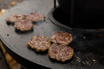 Sizzling, Mouthwatering Burgers Cooking Perfectly on a Griddle at a Summer BBQ Event