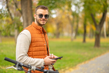 young man with cellphone on bike