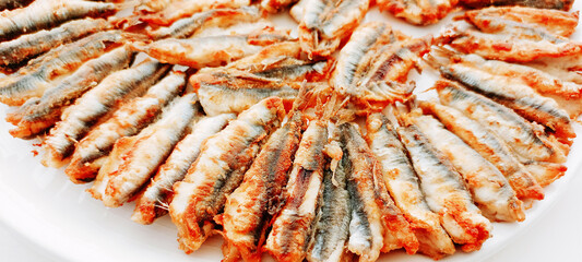 fried anchovies in a frying pan, fried anchovies (TURKEY anchovies), anchovy fish, fried anchovies in a salad plate, collage from different photos of delicious seafood