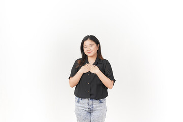 beautiful Asian woman places her hand gently on her chest, expressing sincerity or gratitude,...