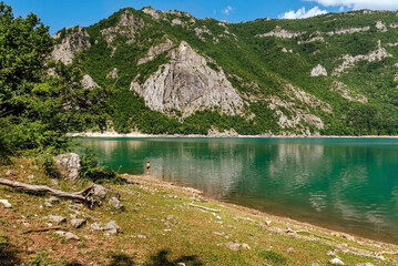 Small Person in Big Landscape of Piva Mountain Lake