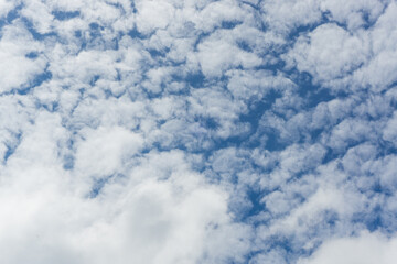 Fototapeta premium Many clouds on a bright blue sky background in a beautiful day