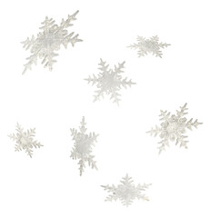 Christmas holliday image, Christmas bauble in shape of a white snowflakes falling in the air isolated on white background