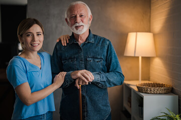 Elderly Man With Caring Woman in Warm Living Room Setting