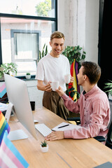 Two happy men share a warm exchange with coffee cups in a bright workspace filled with plants.