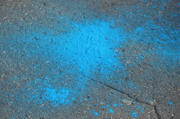 Bright colored spots of powder paint on the asphalt.