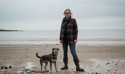 woman with dog on beach