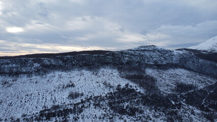 Aerial view on snow covered mountains in winter