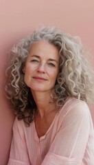 Warm Portrait of Middle-Aged Woman with Curly Hair Against Pink Background for Positive Vibe Posters