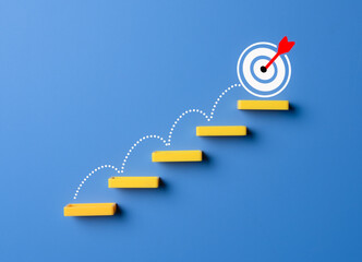 Stairs made by wooden blocks with the target icon at the top. goals concept, achievement or...