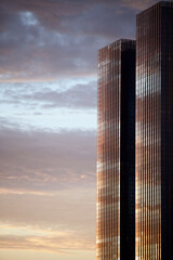 Glass surface of city skyscraper facades in the morning light. Commercial real estate. Modern business city district. Office buildings exterior closeup. Financial city district. Downtown.