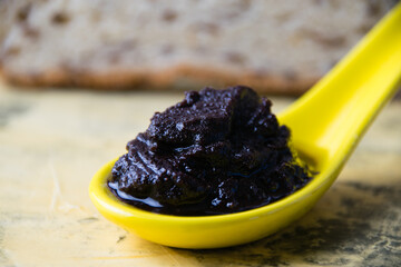 Chocolate paste with nuts and white bread with sesame macro on a light background. Concept of calories and junk food.