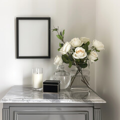 A small vertical poster is framed and positioned above a stylish grey marble side table. Roses in glass vases, lit candles, and a contemporary jewelry box complete the refined setting.
