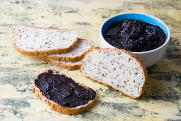 A tasty and nutritious snack of white bread with chocolate paste on a light background. Concept of calories and junk food.