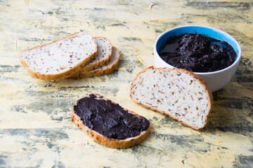 A tasty and nutritious snack of white bread with chocolate paste on a light background. Concept of calories and junk food.