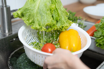 people washing raw vegetables at sink in the kitchen prepare ingredient for cooking