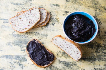 A tasty and nutritious snack of white bread with chocolate paste on a light background. Concept of calories and junk food.