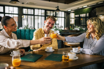 Group of friends toasting with drinks in a pub.