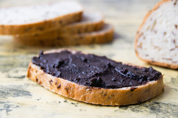 A tasty and nutritious snack of white bread with chocolate paste on a light background. Concept of calories and junk food.