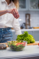Cooking concept. Woman hands making healthy dinner, cutting vegetables on chopping board, kitchen interior, closeup