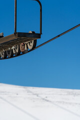 A minimalist concept of a chairlift cable against a backdrop of snow and clear blue sky, symbolizing winter sports and outdoor adventure.