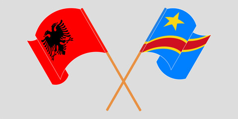 Crossed and waving flags of Albania and Democratic Republic of the Congo. Vector illustration