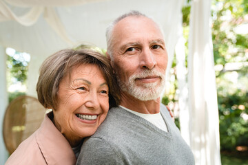 Love and care. Romantic senior old couple grandparents spouses hugging embracing.