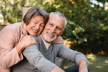 Cheerful european senior old elderly couple grandparents spouses hugging embracing bonding