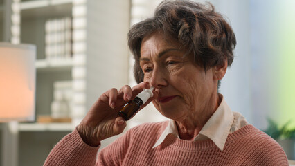 Caucasian sick grandmother unwell senior woman at home unhealthy old female granny allergic elderly...