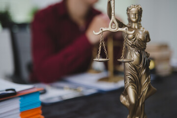 An Asian male lawyer meticulously reviews legal documents, ensuring accuracy and compliance for an...