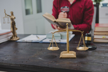 An Asian male lawyer meticulously reviews legal documents, ensuring accuracy and compliance for an...