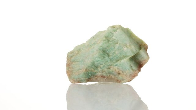 Amazonite mineral stone spinning in a circle on a white background