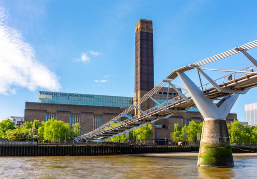 Tate Modern gallery on South bank of Thames river and Millennium bridge, London, UK
