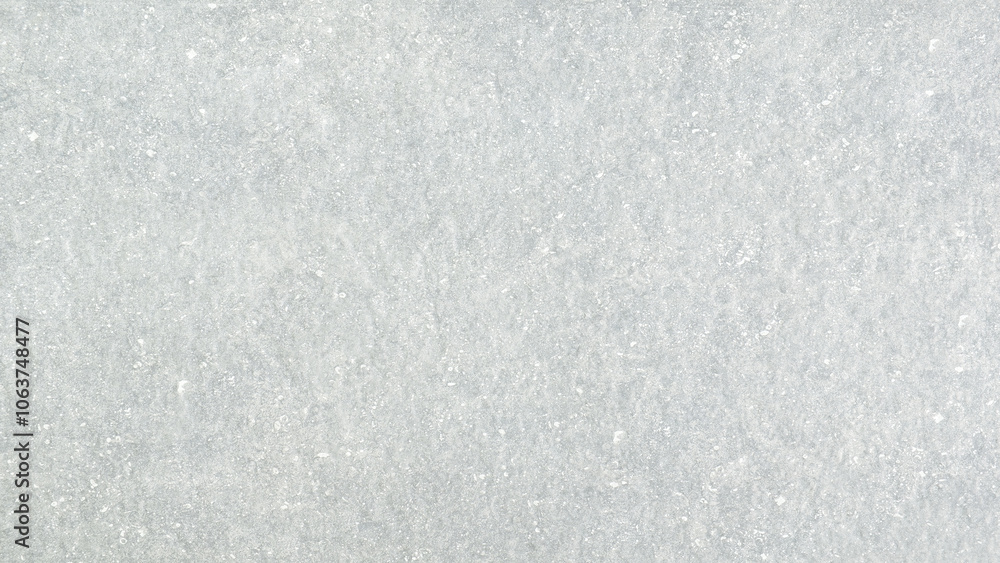 Poster a grey wall with a rough texture. the wall is covered in white paint and has a grainy appearance