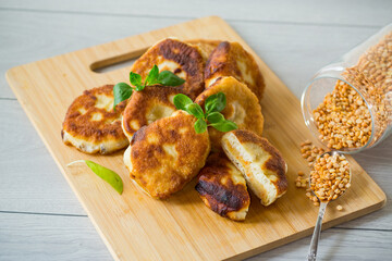 cooked fried pea pies on a wooden board