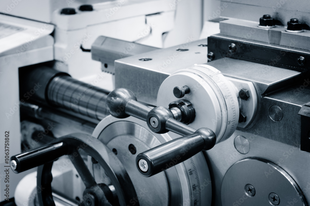 Poster Metalworking lathe with handle and dial vnite. The dial is marked with numbers, and the handle is black.