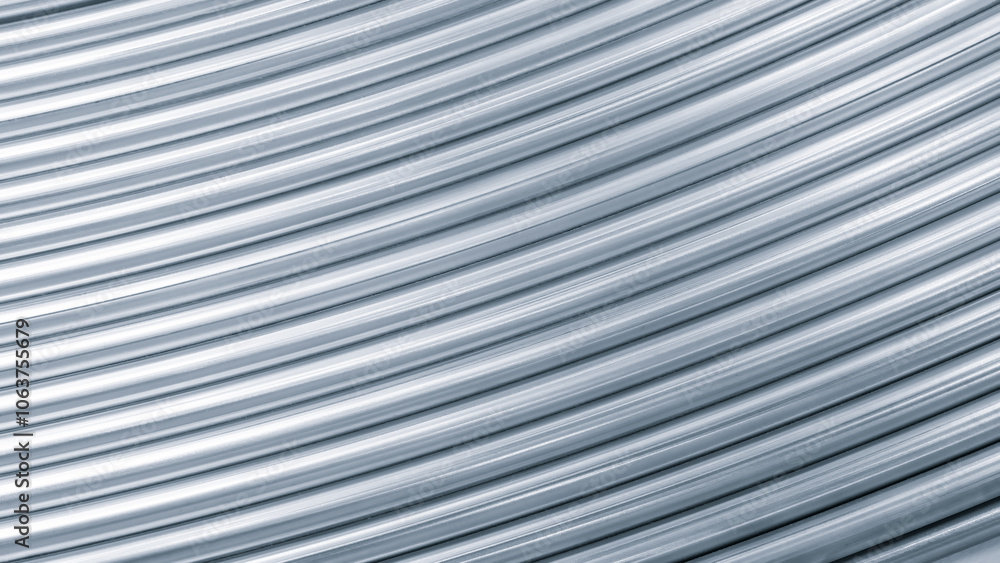 Poster close up of a silver metal surface with a series of lines. The lines are thin and appear to be overlapping, creating a sense of depth and texture. Scene is sleek and modern