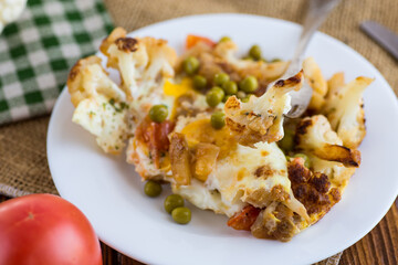 fried omelette with cauliflower and vegetables in a plate