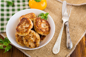 fried chicken cutlets in a bowl on a wooden table