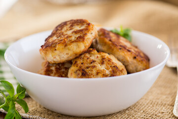 fried chicken cutlets in a bowl on a wooden table