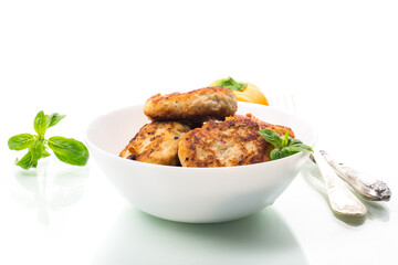 fried chicken cutlets in a bowl, isolated on white background