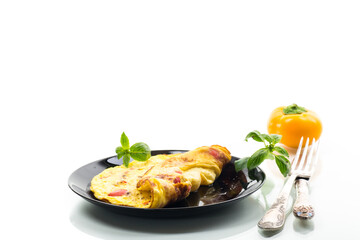 fried omelette with sweet pepper and vegetables in a plate, isolated on white background