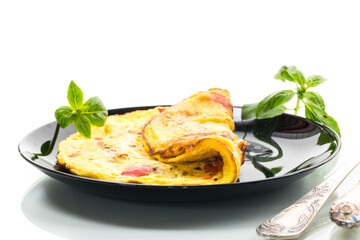 fried omelette with sweet pepper and vegetables in a plate, isolated on white background